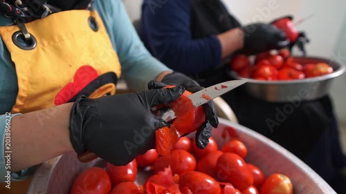 Hand Peeling Fresh Tomato Skin with Knife in Tomato Paste Production