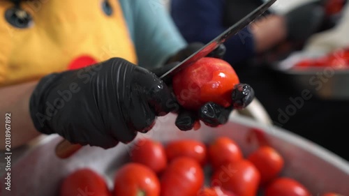 Hand Peeling Fresh Tomato Skin with Knife in Tomato Paste Production