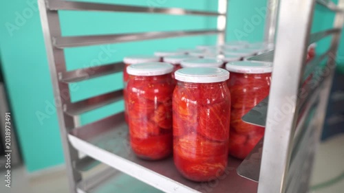 Placing Glass Jars of Peeled Tomatoes on Shelf in Tomato Paste Production Facility