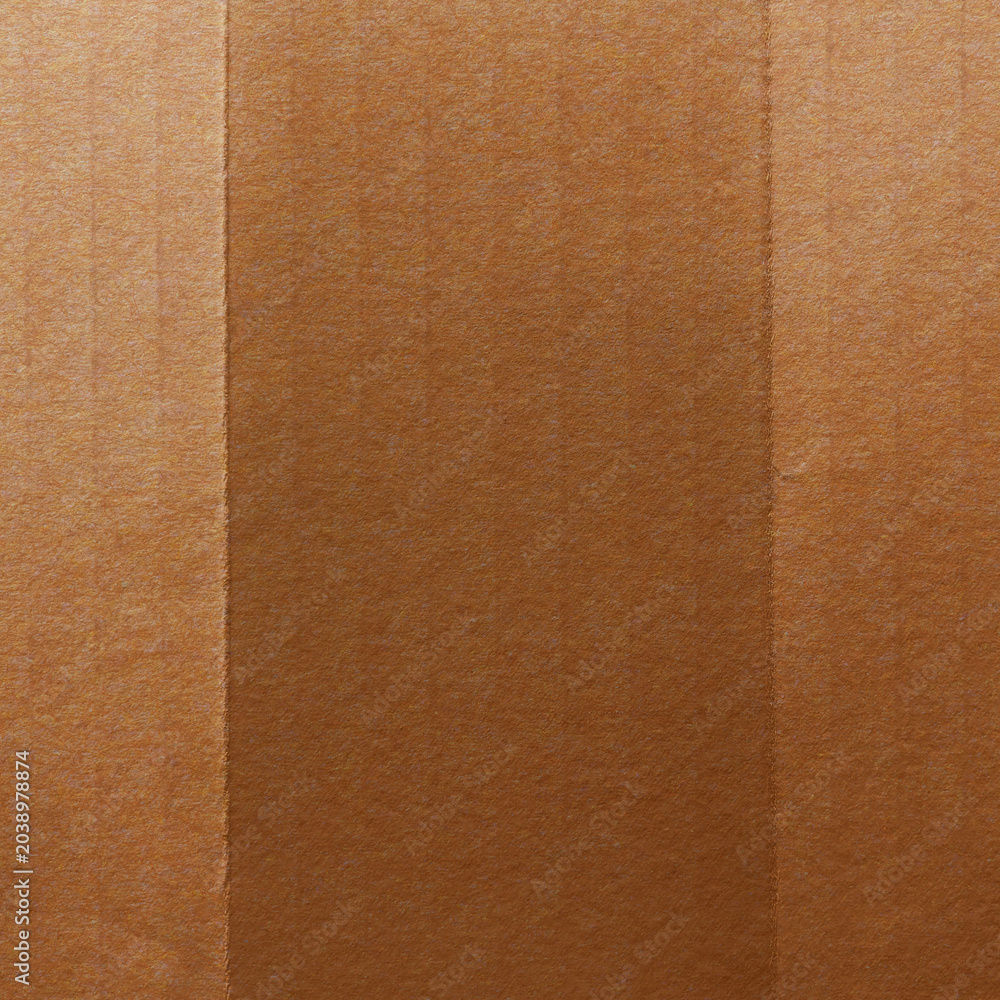 Fototapeta premium Close-up of textured brown cardboard with vertical lines and shading.