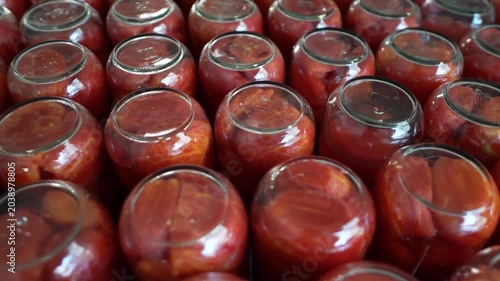 Glass Jars of Peeled Tomatoes on Shelf in Tomato Paste Production Facility