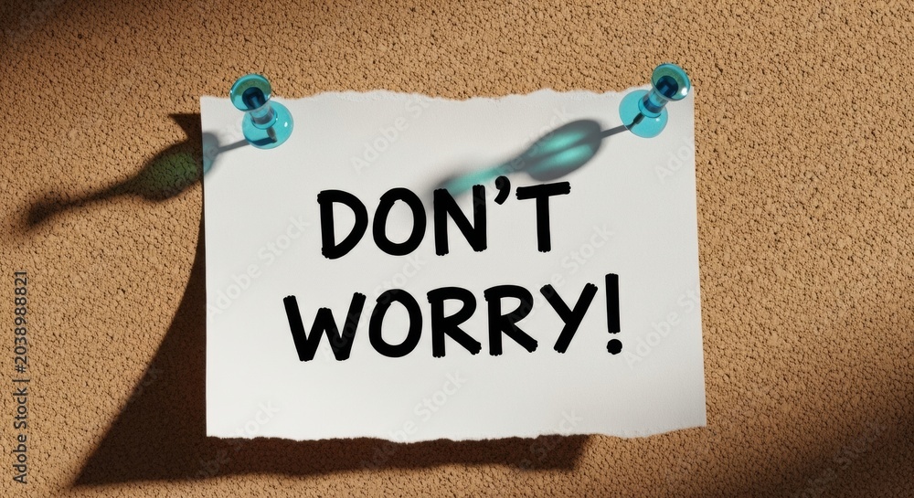 Obraz premium Don't Worry Note Pinned to Corkboard with Blue Push Pins and Strong Graphic Shadows