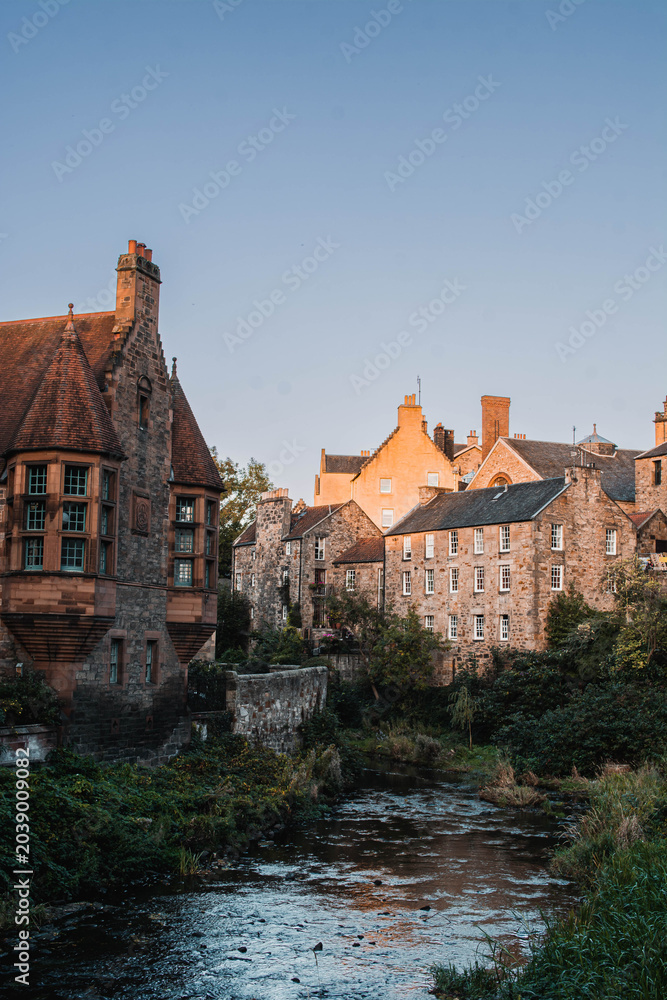 Fototapeta premium Picturesque historic stone houses of Dean Village by the Water of Leith, Edinburgh, Scotland