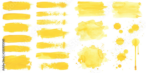 Set of yellow watercolor brush strokes and paint splatters for creative art design projects