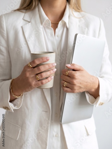 Elegant Businesswoman Working with Laptop and Coffee in Bright Modern Office