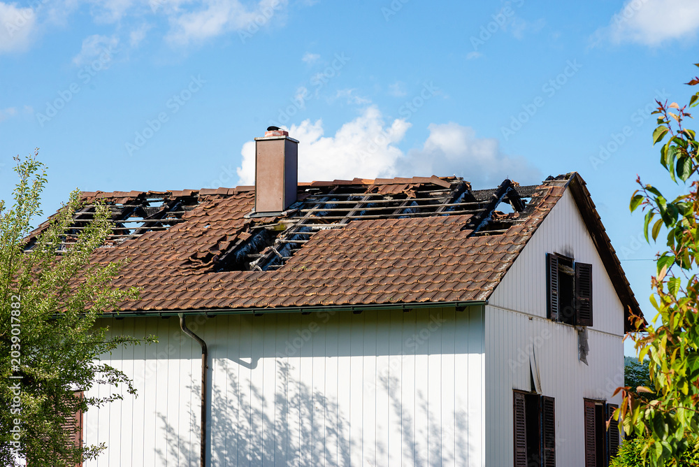 Fototapeta premium House Roof Damage with Broken Tiles
