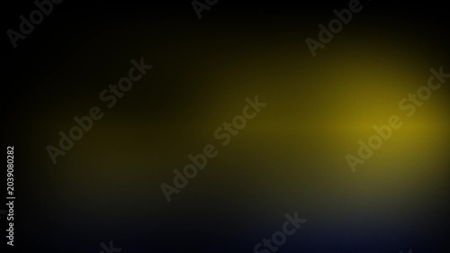 Animation abstract soft gradient light leaks loop motion background on black background. A bright yellow light on a dark background.