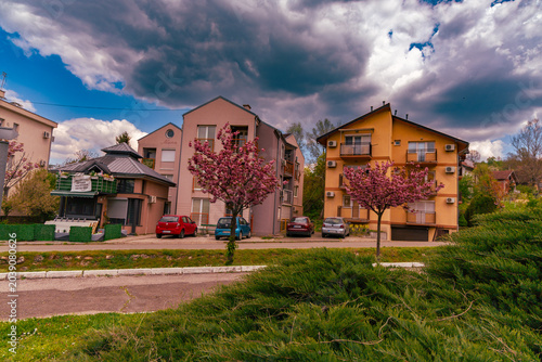 Schilderij op canvas Mira Residential Houses Under Dramatic Spring Sky