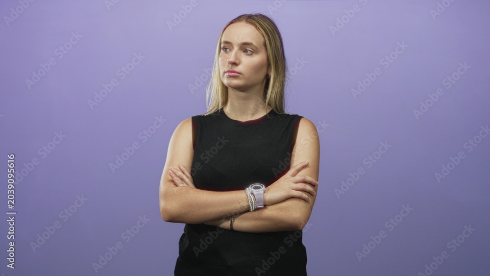 Obraz premium Woman with arms crossed showing watch and forearms, eyes closed in a purple studio portrait; confidence poised calm.