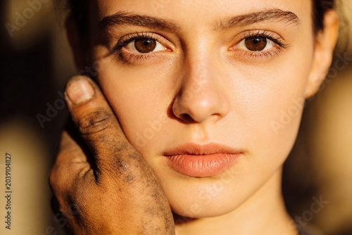 A man's hand touches the face of a beautiful woman. Close-up.