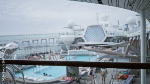 Картината върху платно Cruise ship pool deck blurred and defocused with shallow bokeh, outdoor leisure scene on upper deck with rail and pool out of focus; background backdrop copyspace calm
