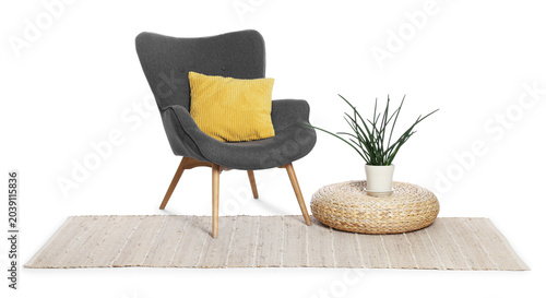 Foto Grey armchair with cushion, rug and houseplant isolated on white