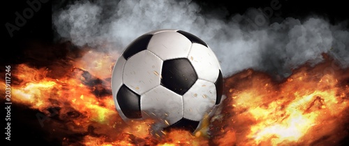 Foto Soccer ball surrounded by vibrant flames and dark smoke, creating an explosive v