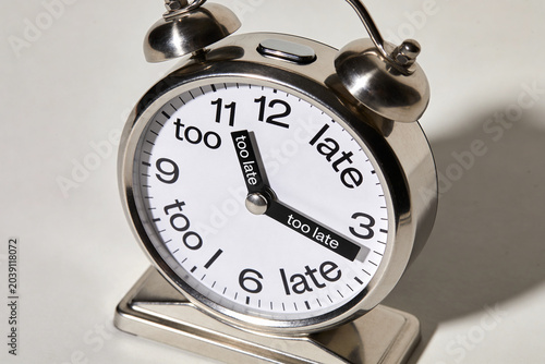 clock with the inscription: too late