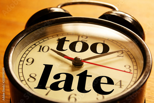 clock with the inscription: too late