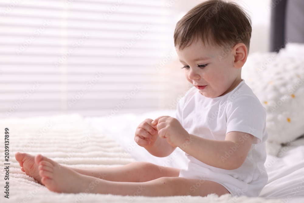 Fototapeta premium Cute little baby boy on bed at home. Space for text