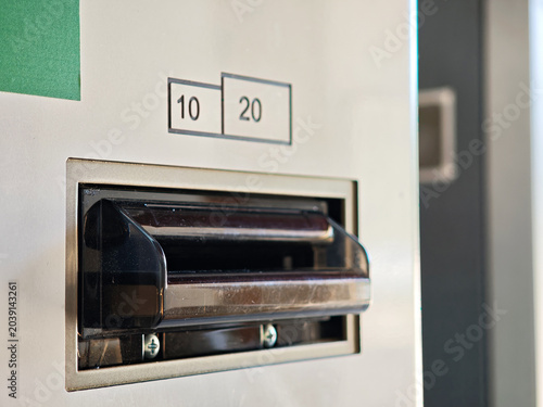 Принти на полотні Close-up of a cash intake slot on a vending machine with 10 and 20 banknote deno