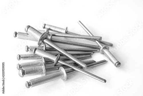 Schilderij op canvas Pop rivets heap on a white background