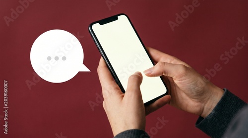Person Typing on Phone Dark Maroon Background Messaging