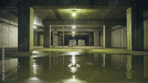 Partially Built Underground Concrete Structure with Dripping Water and Reflections