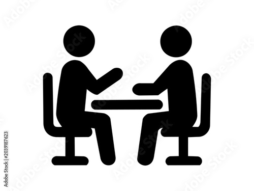 Office discussion icon with two people seated at a table