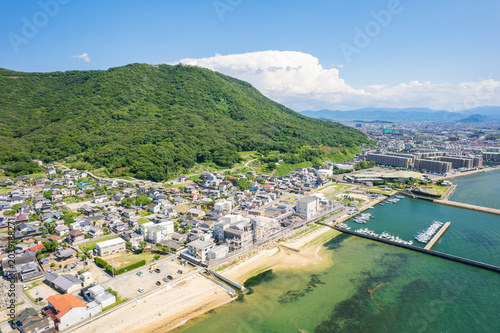 Aerial view of Takamatsu city, Yashima and Seto Inland Sea under summer cumulus clouds in Kagawa Japan
