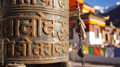 Spinning tibetan prayer wheel at a mountain monastery