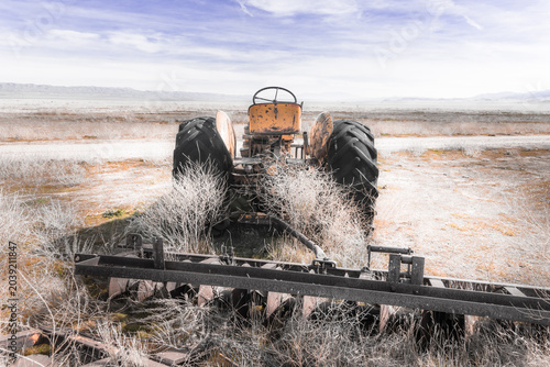 Принти на полотні Abandoned farm tractor on the Carrizo Plain grasslands, California, with intense mid-day sun and distant horizon