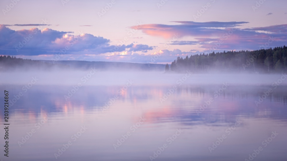 Fototapeta premium Misty Lake at Dawn with Forest Reflection