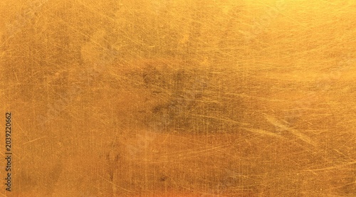 Foto Shiny brushed gold texture background with scratches