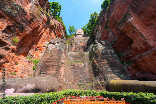 Low angle view of the majestic Leshan Giant Buddha sitting carved into the sandstone cliff face in Sichuan, China