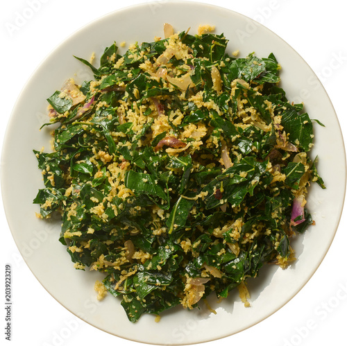cooked murunga leaves side dish on plate isolated white background, traditional food mixed with grated coconut top view