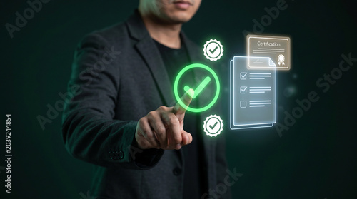 Certification checklist approved with green verified badge touched by businessman