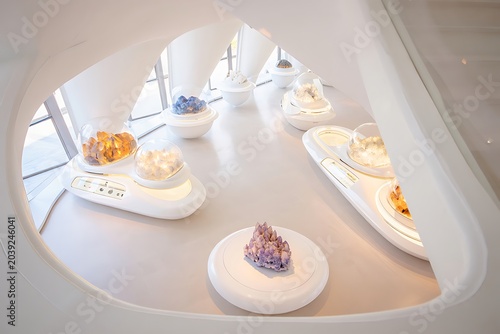 Futuristic laboratory exhibition featuring rare earth minerals and crystal specimens, illuminated dramatically to highlight geological beauty, scientific research, innovation, discovery, and education