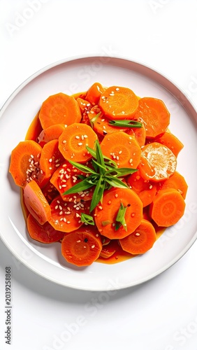 Carrot salad on white plate with glaze, garnish