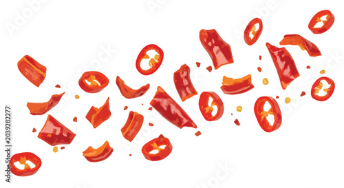 Foto Red chili pepper slices falling on white background, spicy hot pepper pieces and