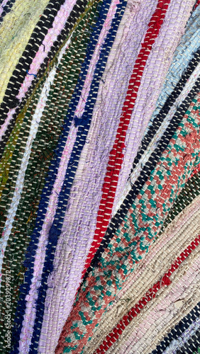 Schilderij op canvas Homespun carpets made with various colors and patterns are displayed on a surfac