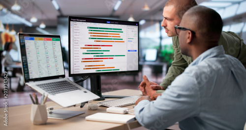 Fotografie Project Manager And Team Review Digital Gantt Chart Tracking Project