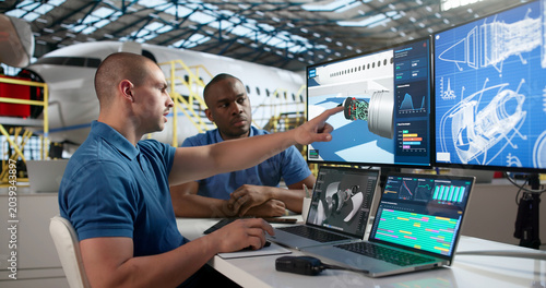 Photos Technicians In Uniform Use Laptop Repairing Jet Engine Parts.