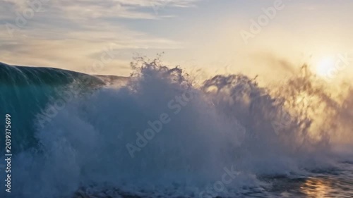 crashing ocean wave at sunset