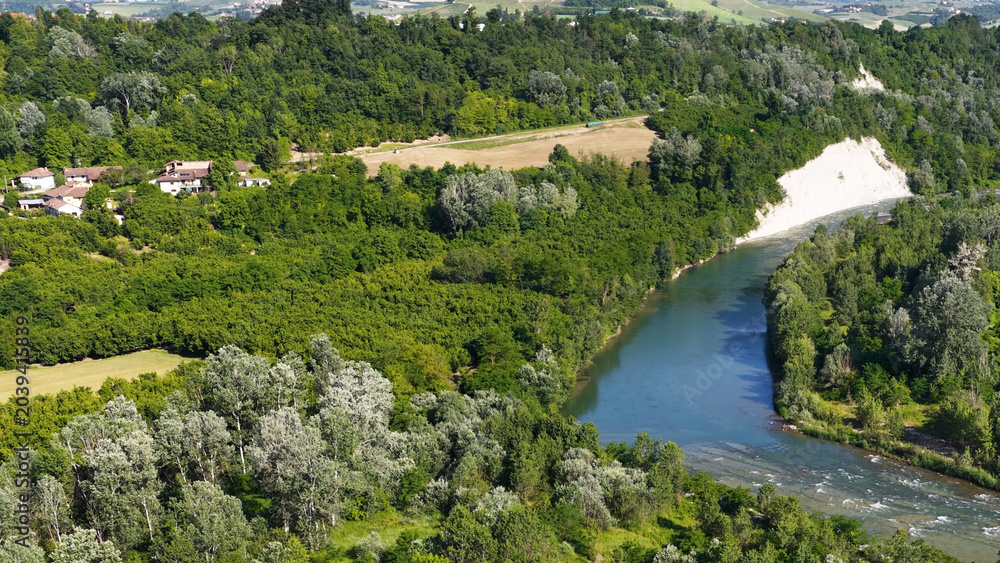 Fototapeta premium Aerial View of Tanaro River Winding Through Lush Piedmont Valley