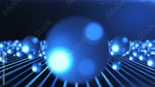 Spheres arranged in a geometric pattern glow with blue light while resting on a dark grid surface created with depth of field.