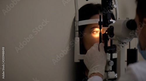 Eye Doctor Examines Patient's Eye With Slit Lamp