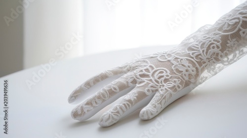 A photo of elegant lace gloves on a white table