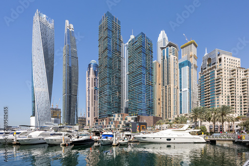 Tableau sur toile Dubai Marina skyline cityscape with yachts skyscraper buildings living at water
