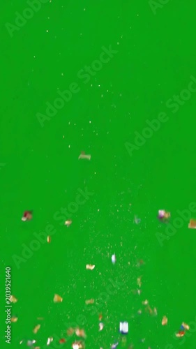 Sparkling colorful confetti explode and burst on green screen background