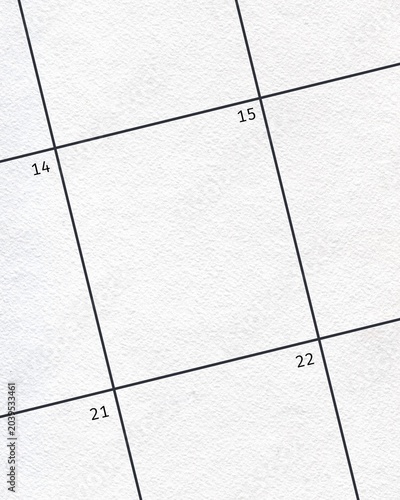 Fotografie Close-up of a blank calendar page grid with dates 14, 15, 21, and 22 visible on textured white paper