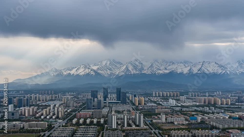 Snowy mountain city skyline with dramatic sunbeams 4K Video