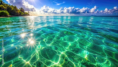 Sunlight shimmers on clear turquoise ocean water with tropical island in the background.