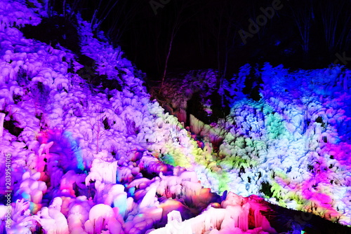 Fotografie Colorfully illuminated Ashigakubo Icicles at night in Chichibu, Saitama, Japan
